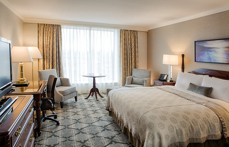 Superior king room with large window, computer desk and flatscreen tv.