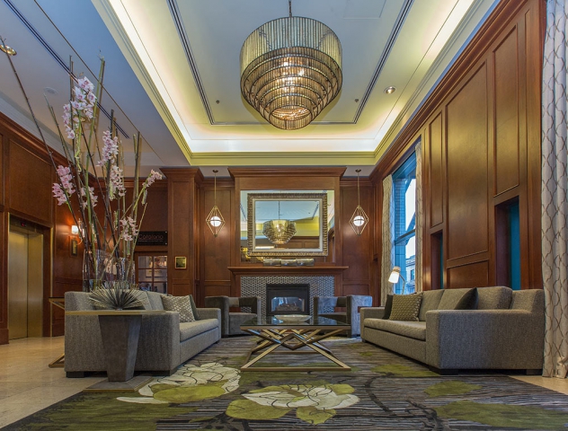 Scenic Bay Hotel Lobby with ornate rugs, modern chandelier and fresh cut tall pink flowers